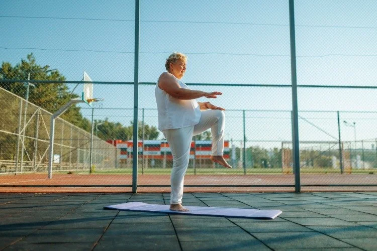 woman doing single leg balance outdoors
