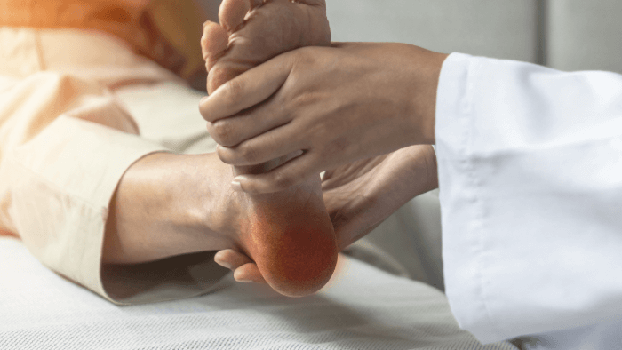 doctor holding foot of patient
