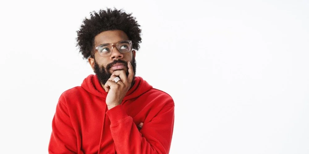 man thinking with his hand on his chin
