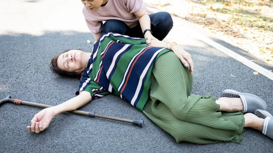 older woman on ground after a fall