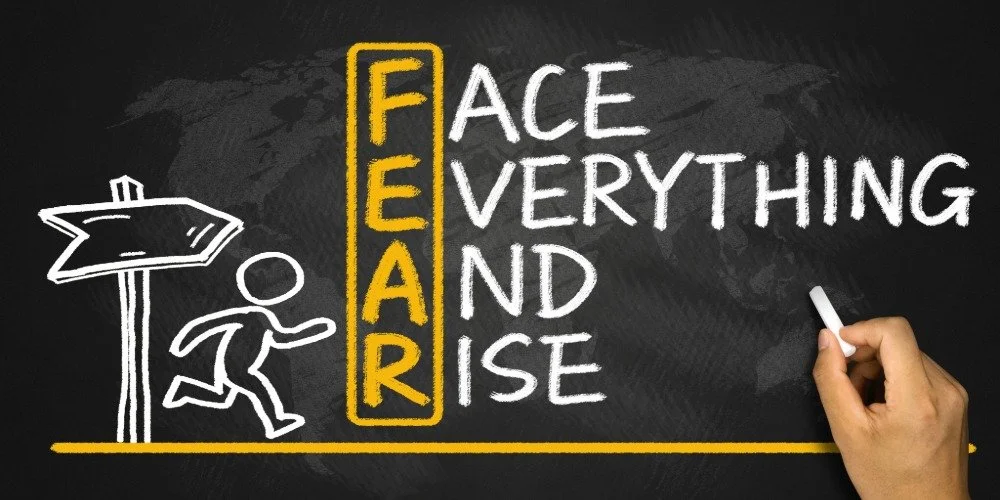 blackboard drawing showing the acronym FEAR (face everything and rise)