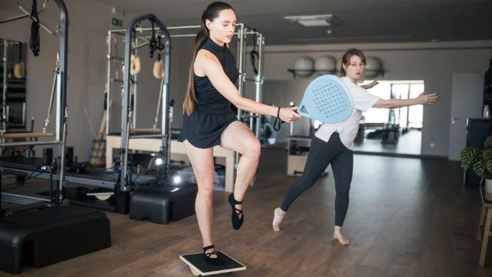 woman getting balance lesson from trainer