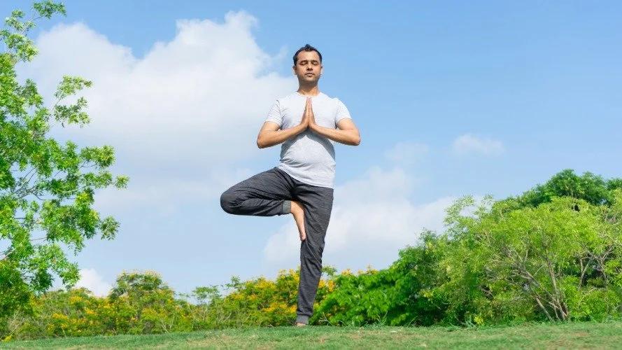 man balancing on one leg