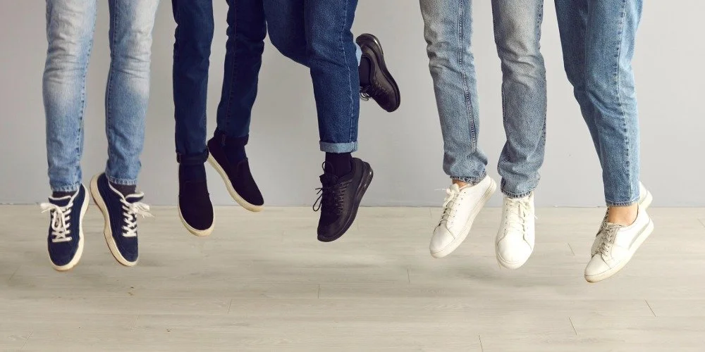 group of people jumping in the air, only can see their feet