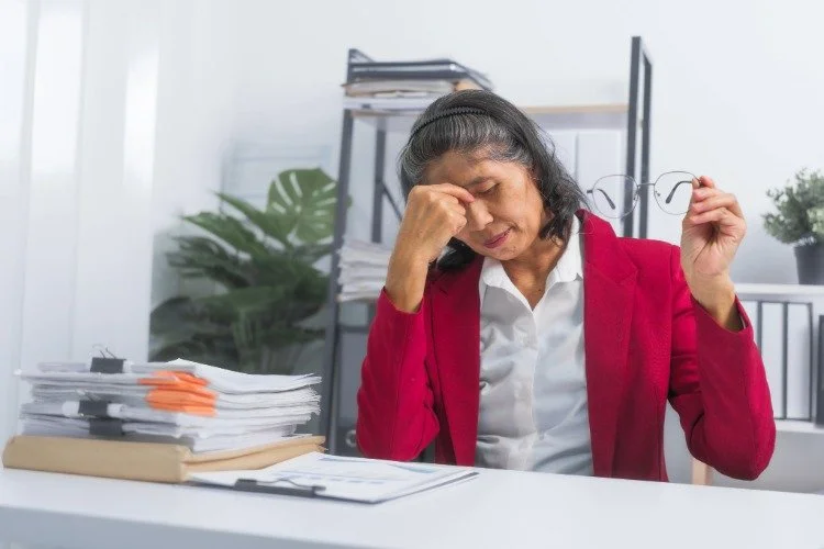 woman tired and rubbing her eyes