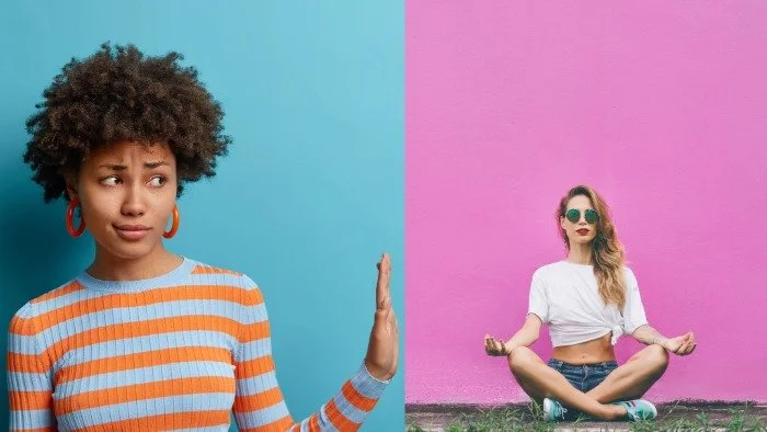 woman putting her hand up as if to say no to a woman sitting on the ground