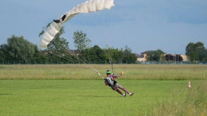 skydiver landing on the ground with speed
