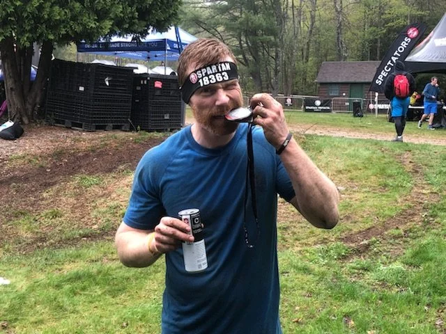 brent at the end of his race celebrating with his medal