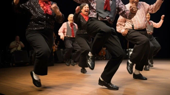 group of older adults tap dancing on stage