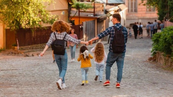 happy family walking down street travelling