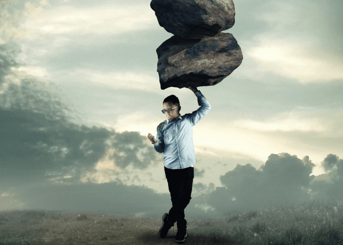 kid holding rocks above his head