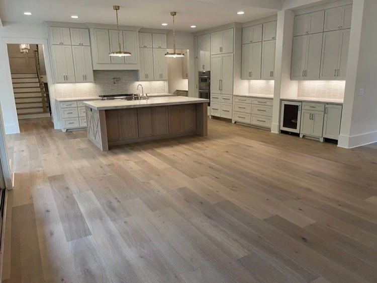 white kitchen cabinets with light brown flooring