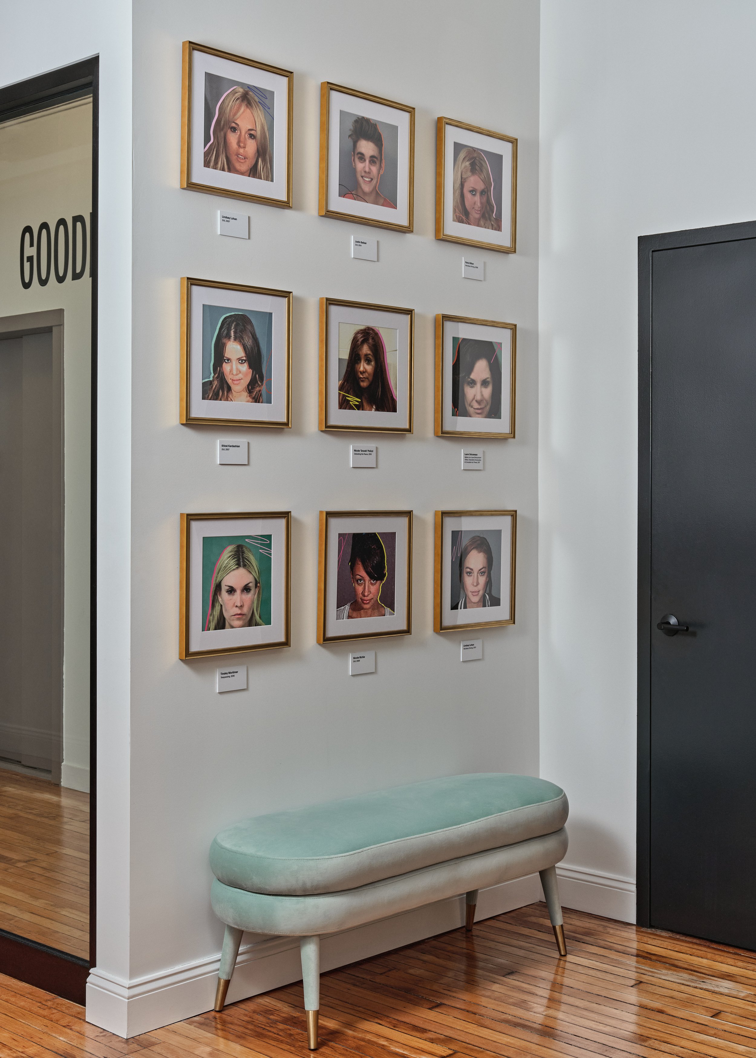 Mugshot gallery wall with custom artwork and bench in Betches office designed by Molly Torres Portnof of DATE Interiors