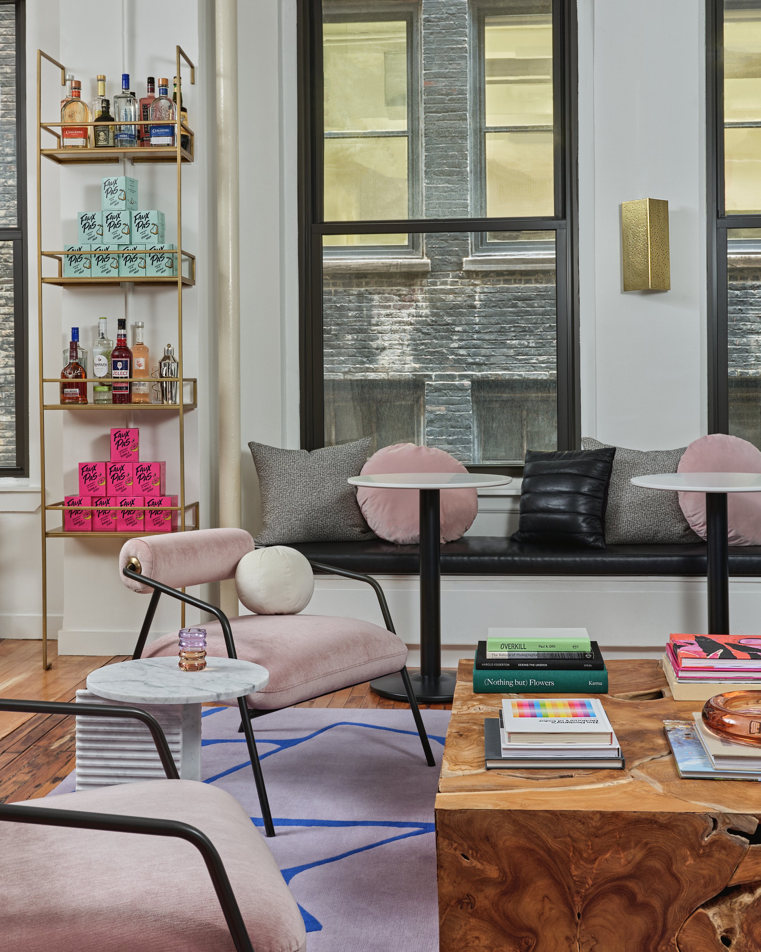 Betches lounge and banquette eating area with custom shelving unit and benches and bench in Betches office designed by Molly Torres Portnof of DATE Interiors