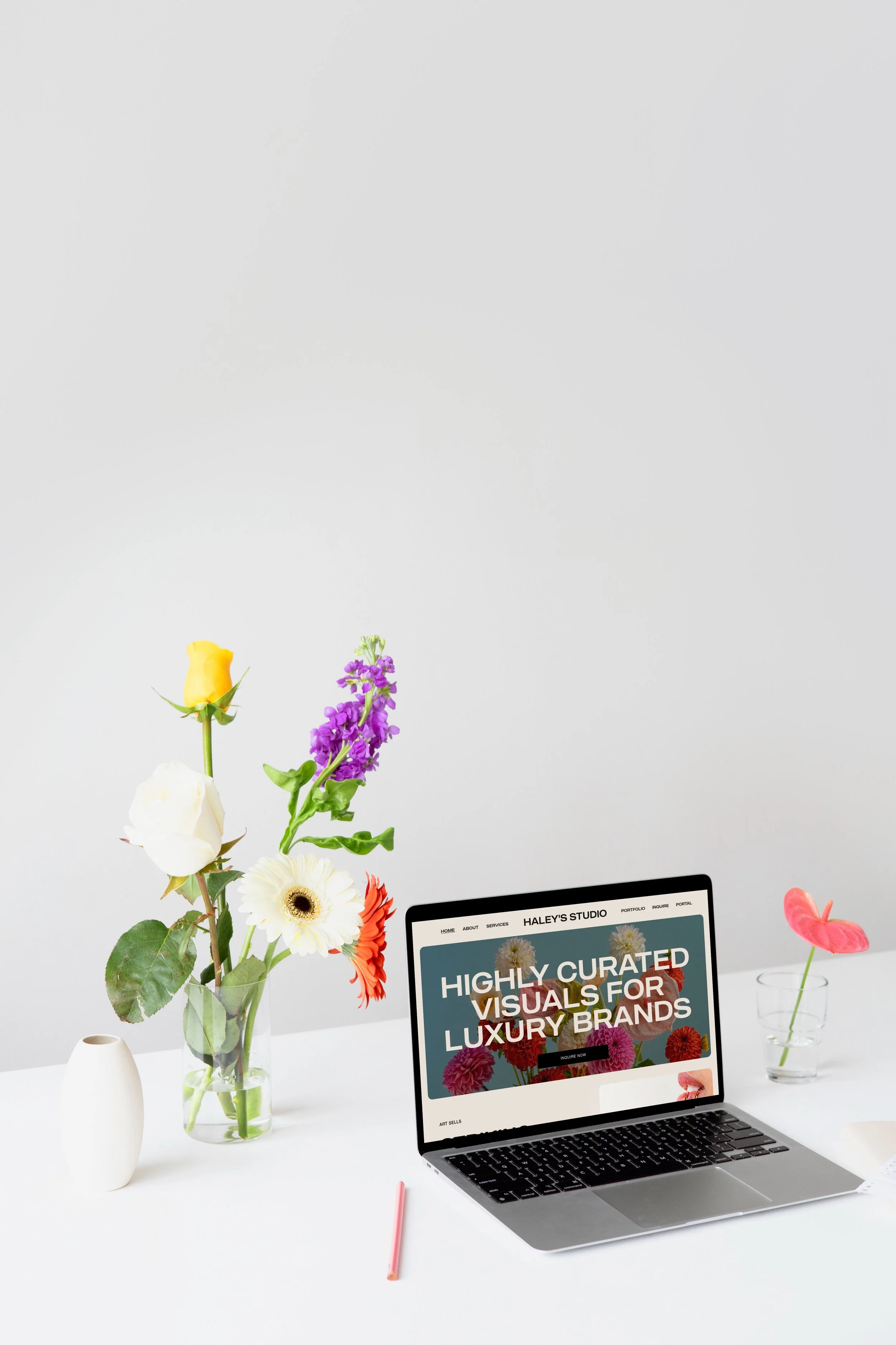 mockuuups-macbook-mockup-on-a-white-table-with-beautiful-flowers-in-a-transparent-vase.jpeg