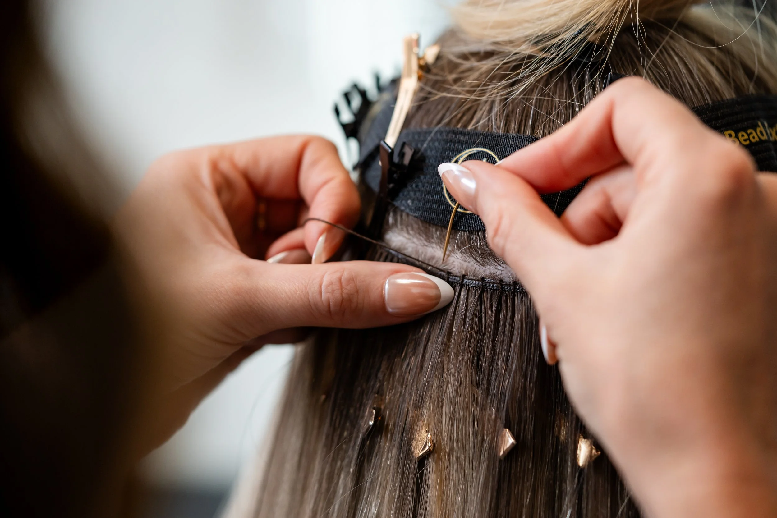 Close up of sewing in IBE extensions in Western Mass Northampton