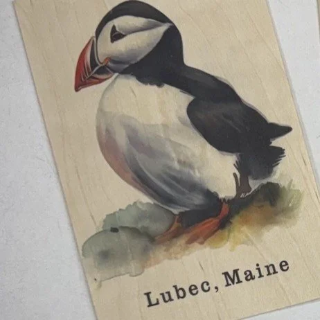Souvenir magnet with a vintage illustration of a puffin bird with the text 'Lubec, Maine' at the bottom.