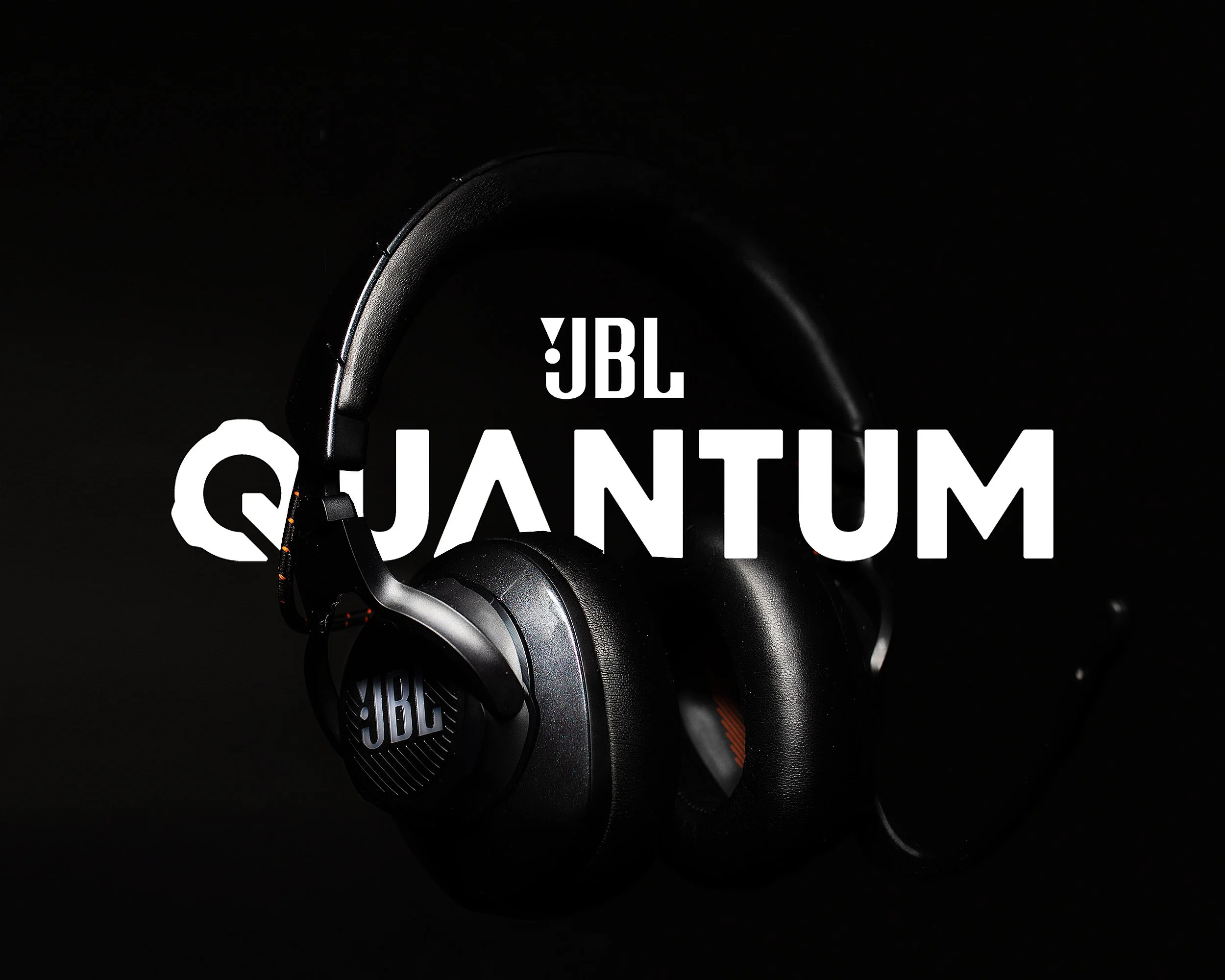 Black JBL Quantum headphones with the JBL logo, and the text 'JBL Quantum' overlayed in white.