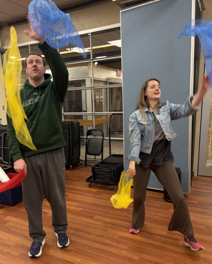 Two clowns juggle scarves