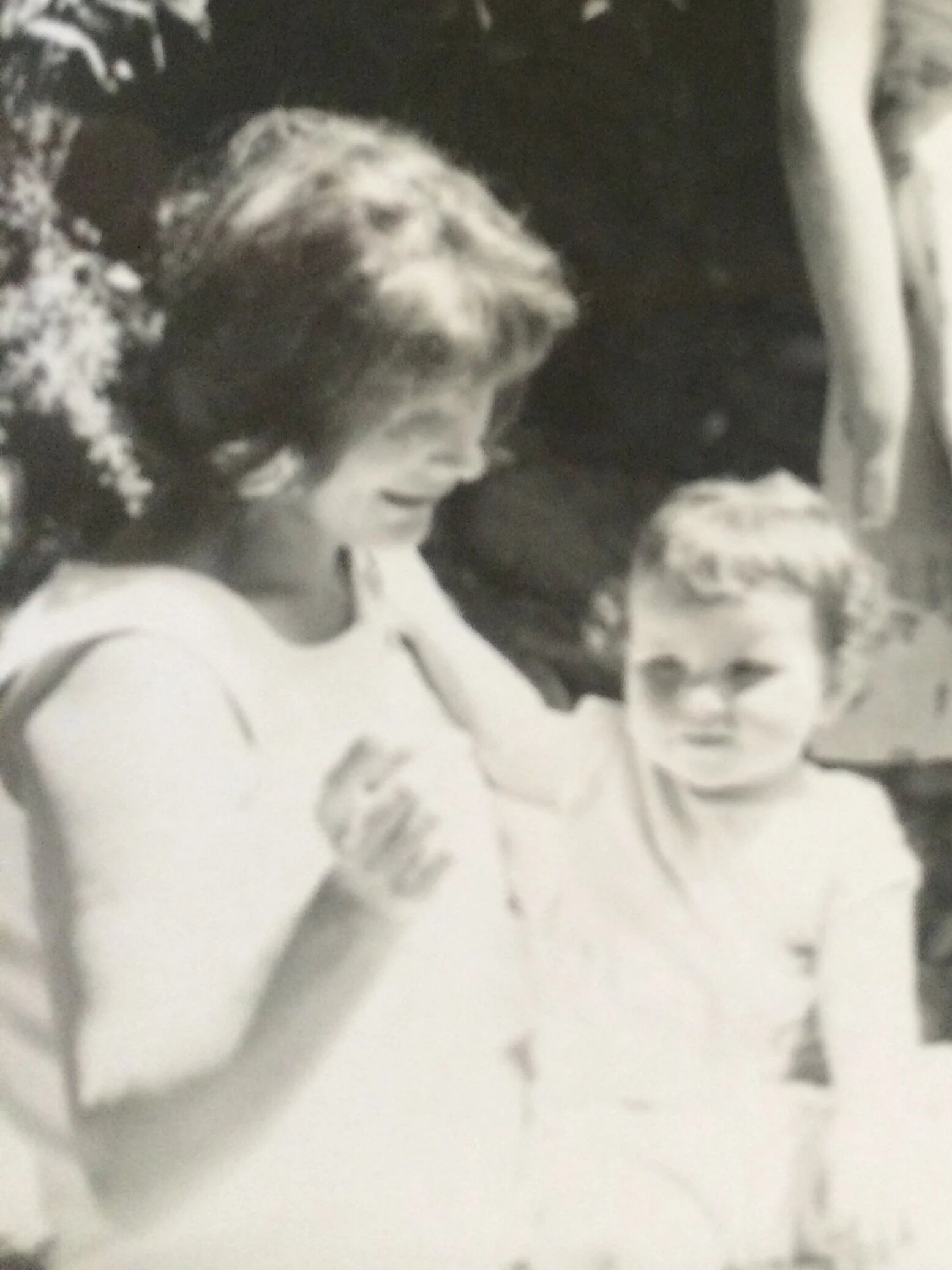 My first family holiday, arm on my mother’s shoulder, held in her gaze.