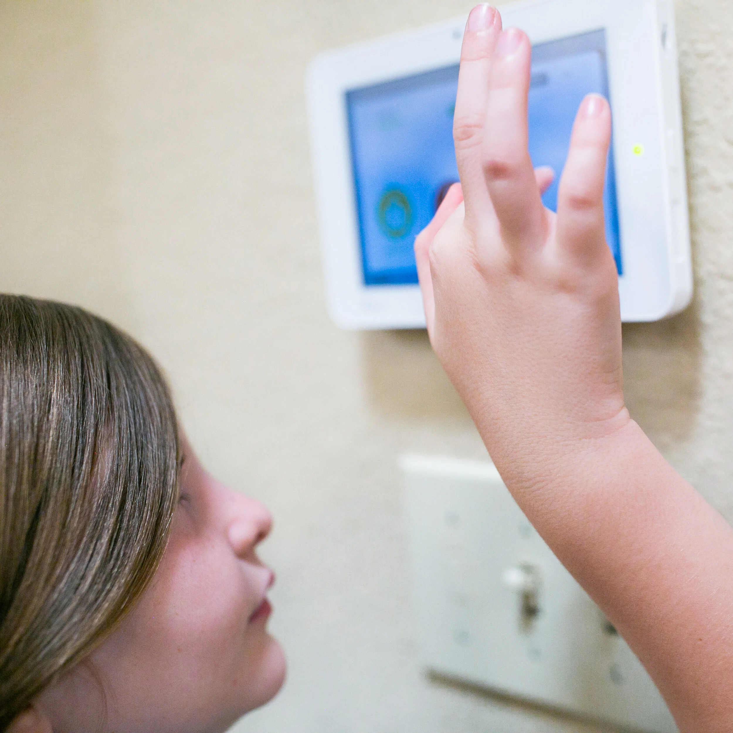 Woman arming a home security keypad