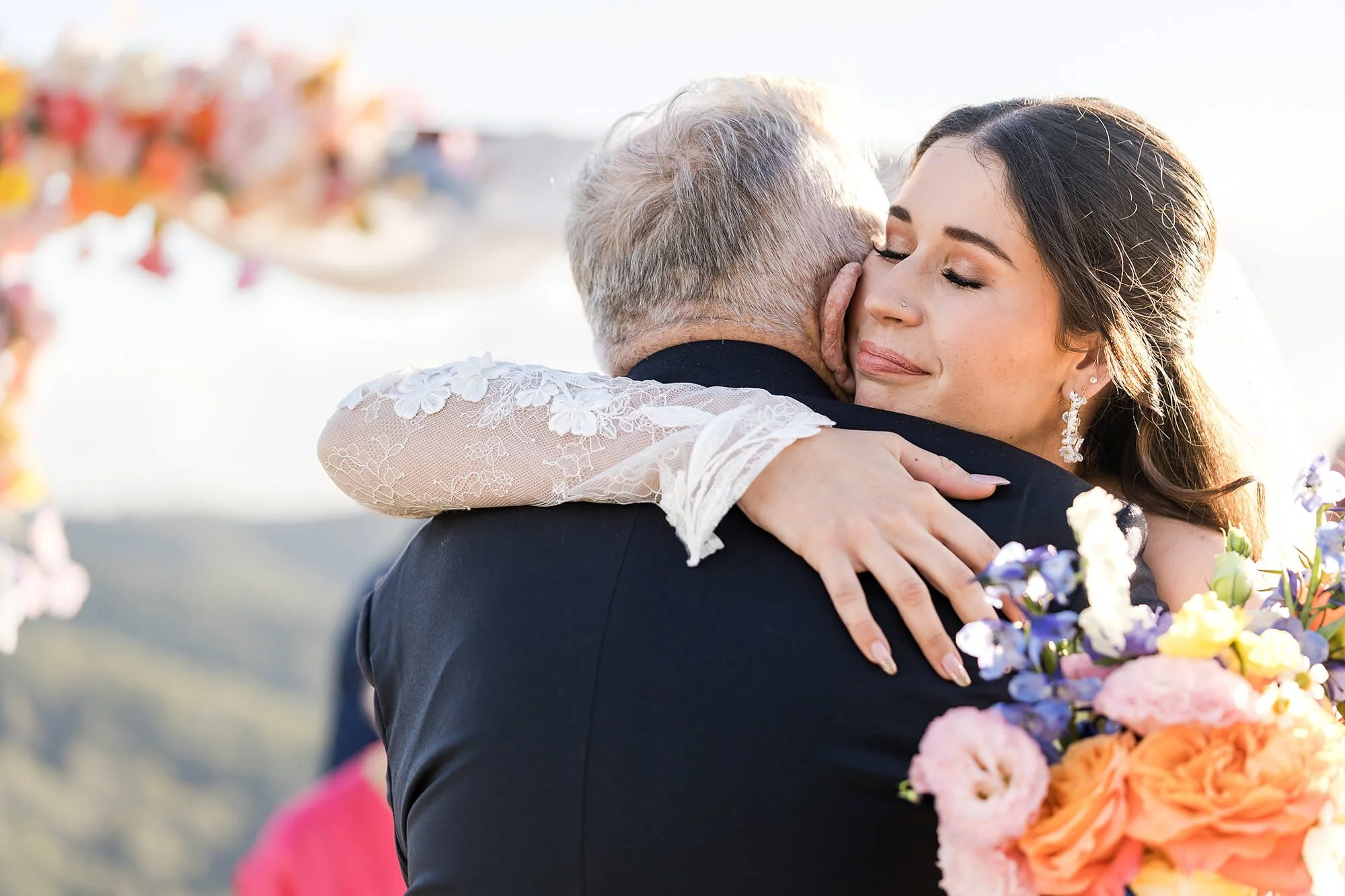 bride hugs her grandfather at her wedding