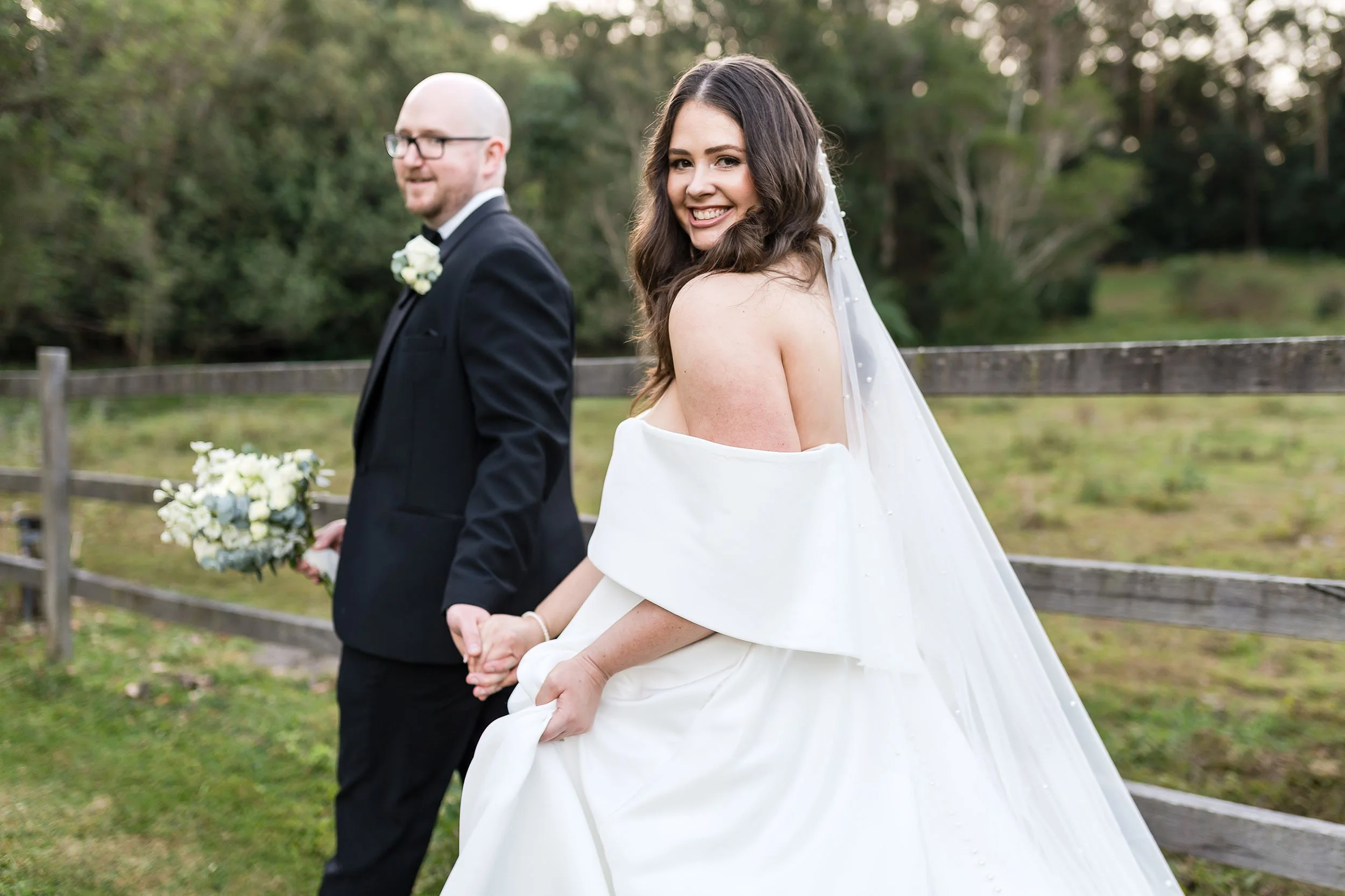 bride & groom walk through country wedding venue