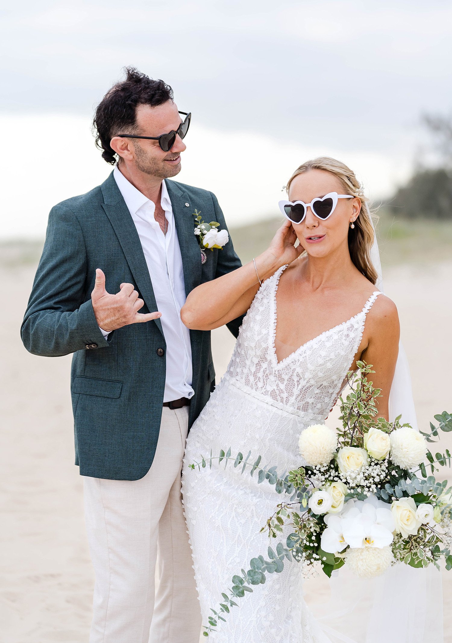 bride and groom have fun in their beach wedding photos
