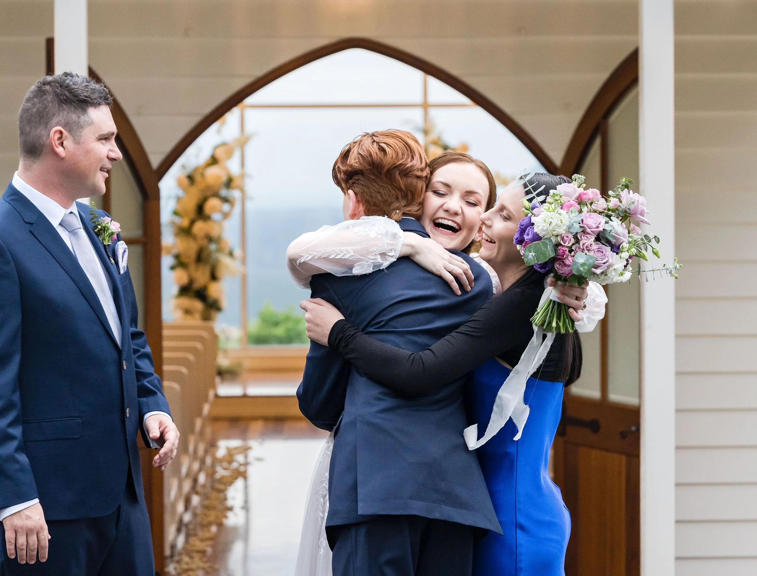 happy couple hugs guests