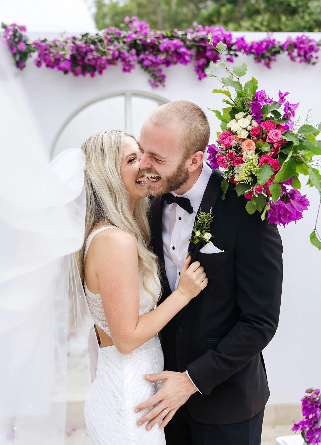 bride and groom laugh at their wedding