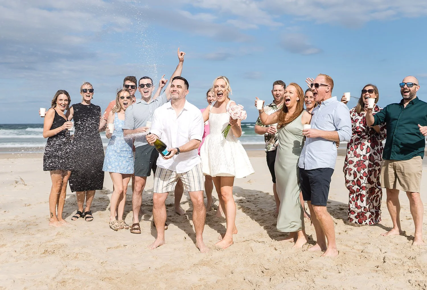 fun wedding photos with guests on the beach