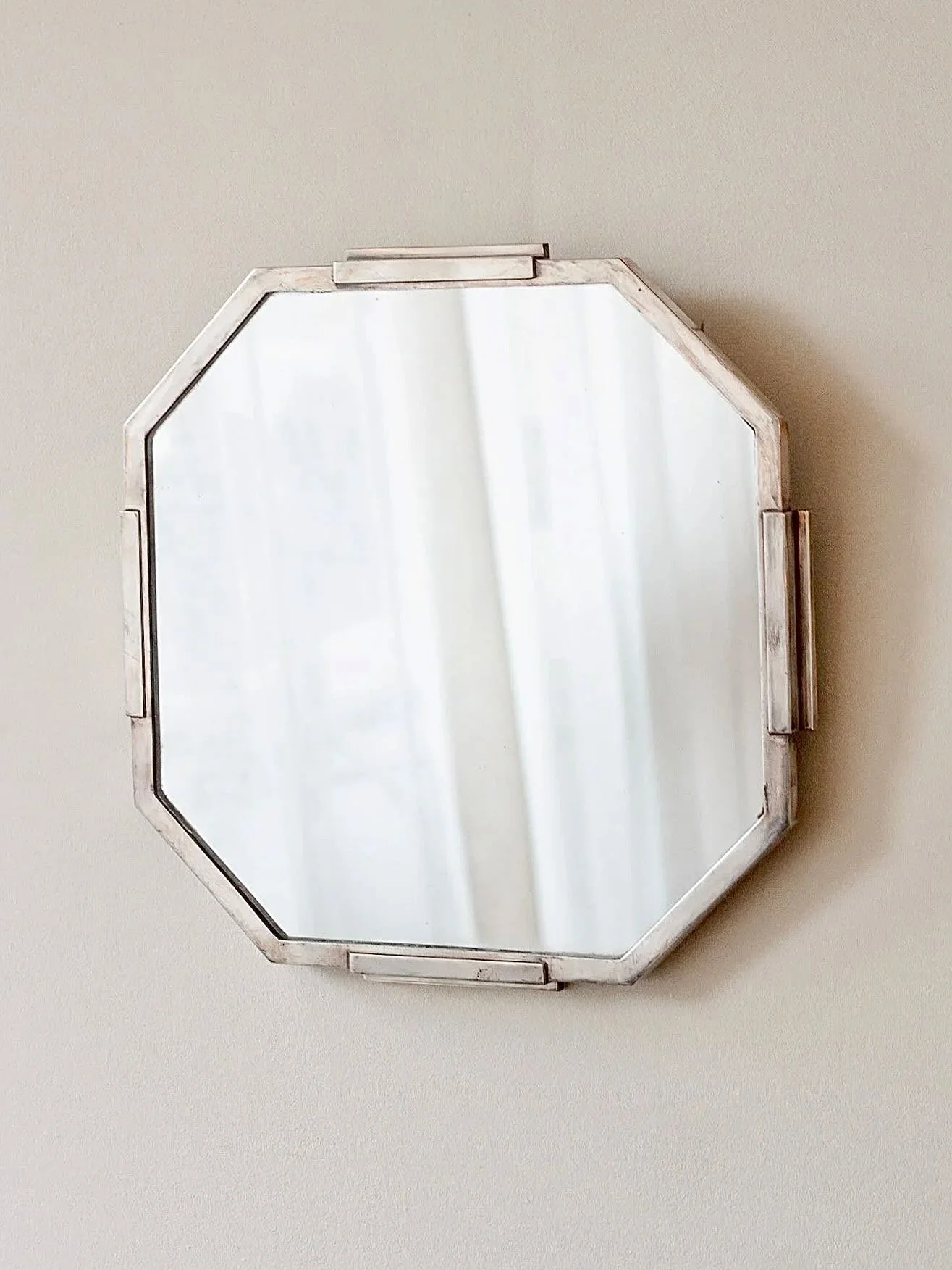 Now sold; An Art Deco octagonal silver plated mirror with stepped detail.

France, C1920

35 &times; 35cm