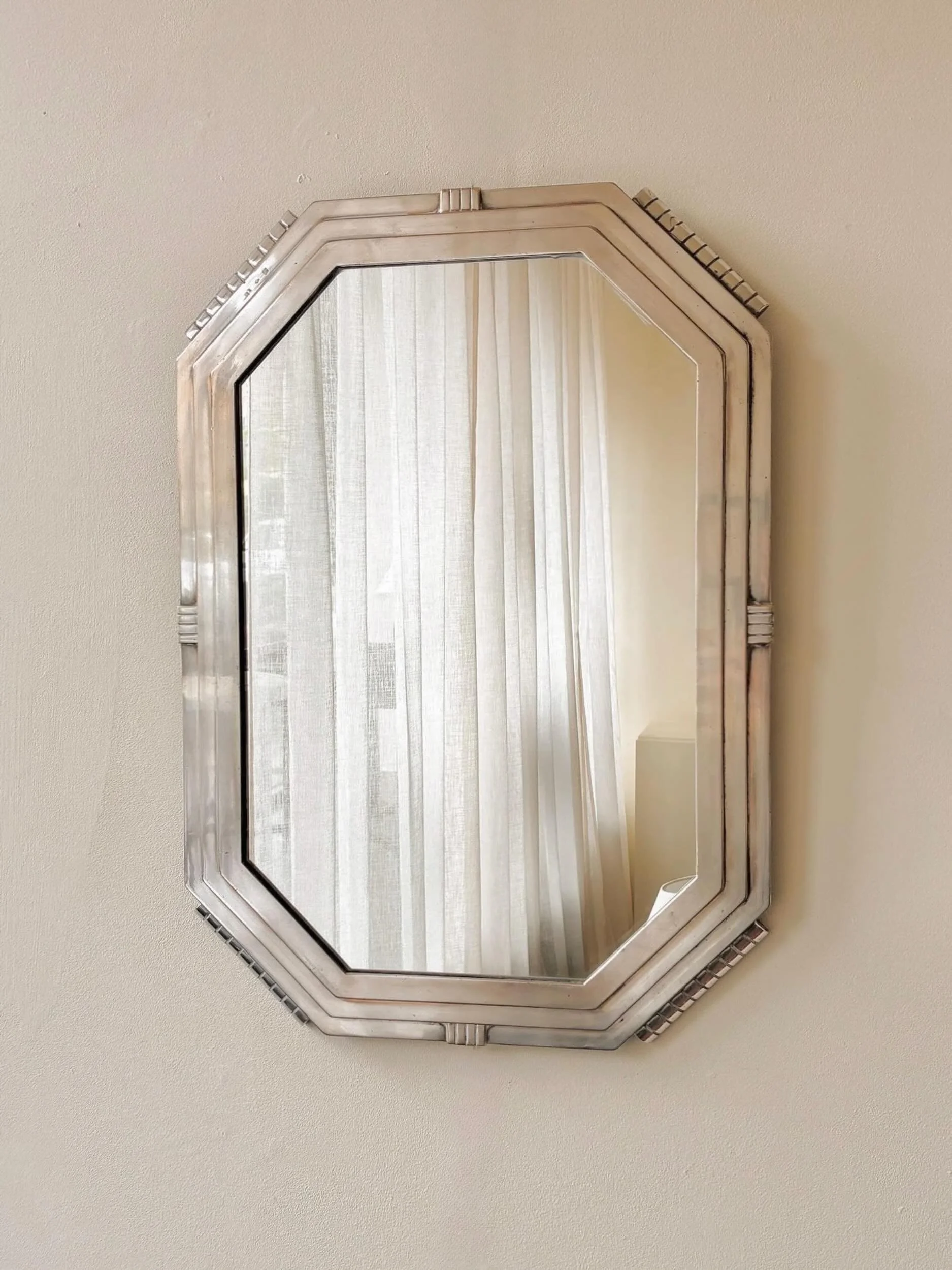 Now sold; Christofle geometric wall mirror in silver plated brass with triple stepped frame. French, C1930.