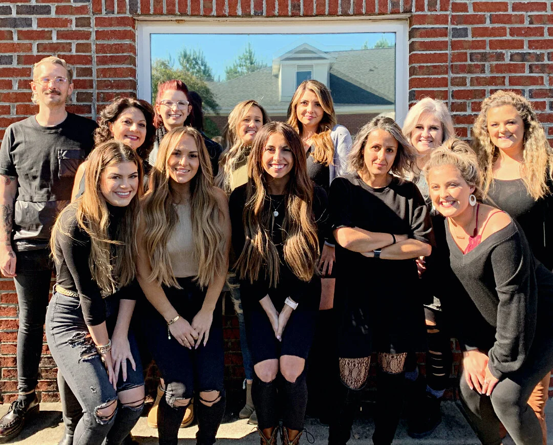 Amy with her salon team at an education event