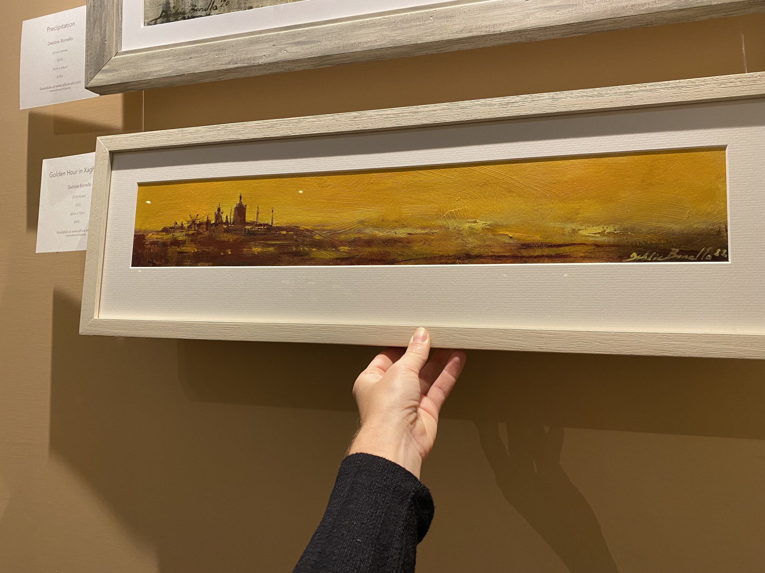 Debbie Bonello's oil painting, Golden Hour in Xaghra, Gozo on the wall
