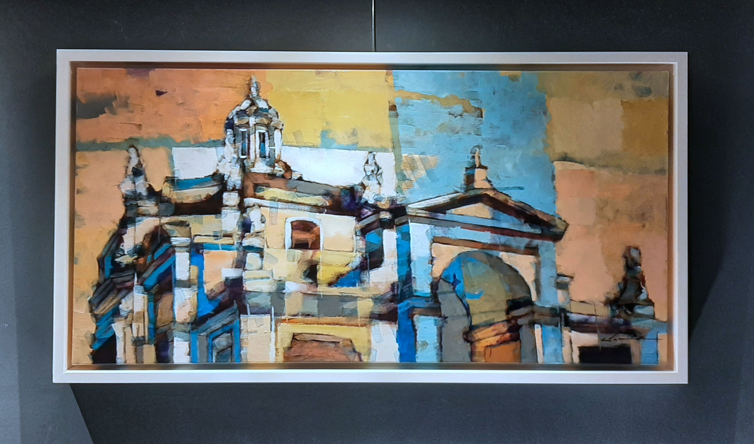 Colourful acrylic painting exhibited on the wall.