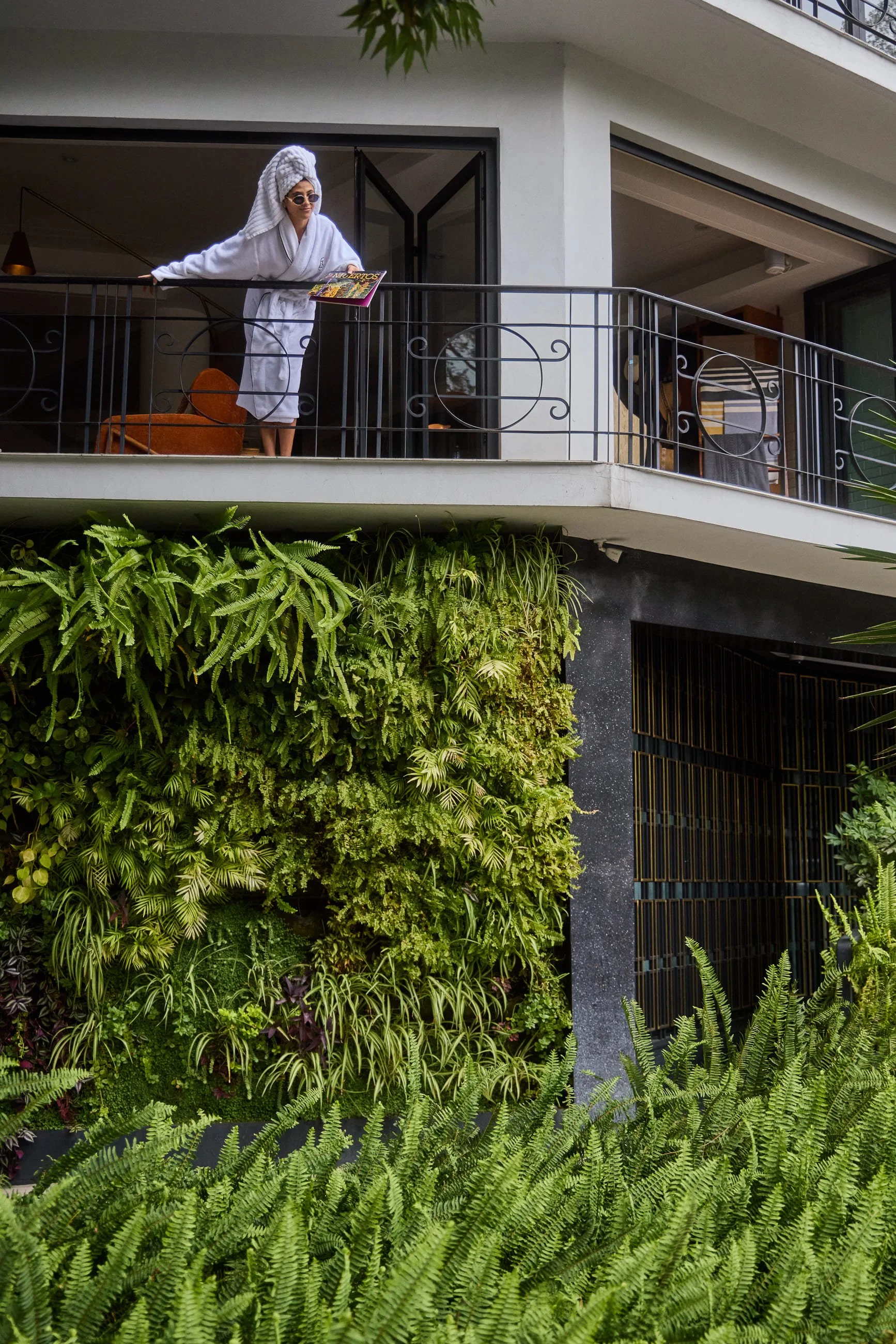 Woman overlooking balcony in room.