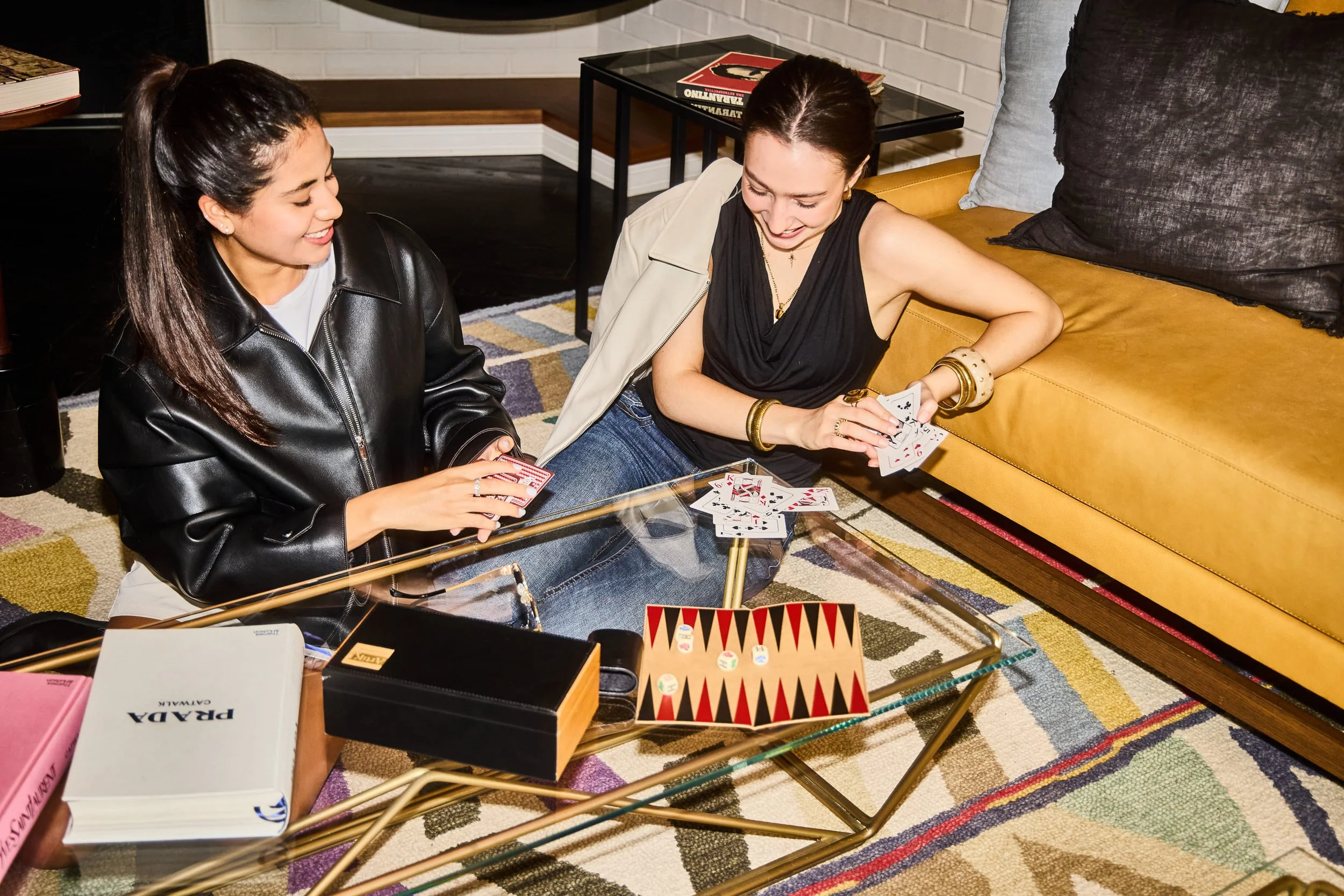 Two women playing board game in hotel.