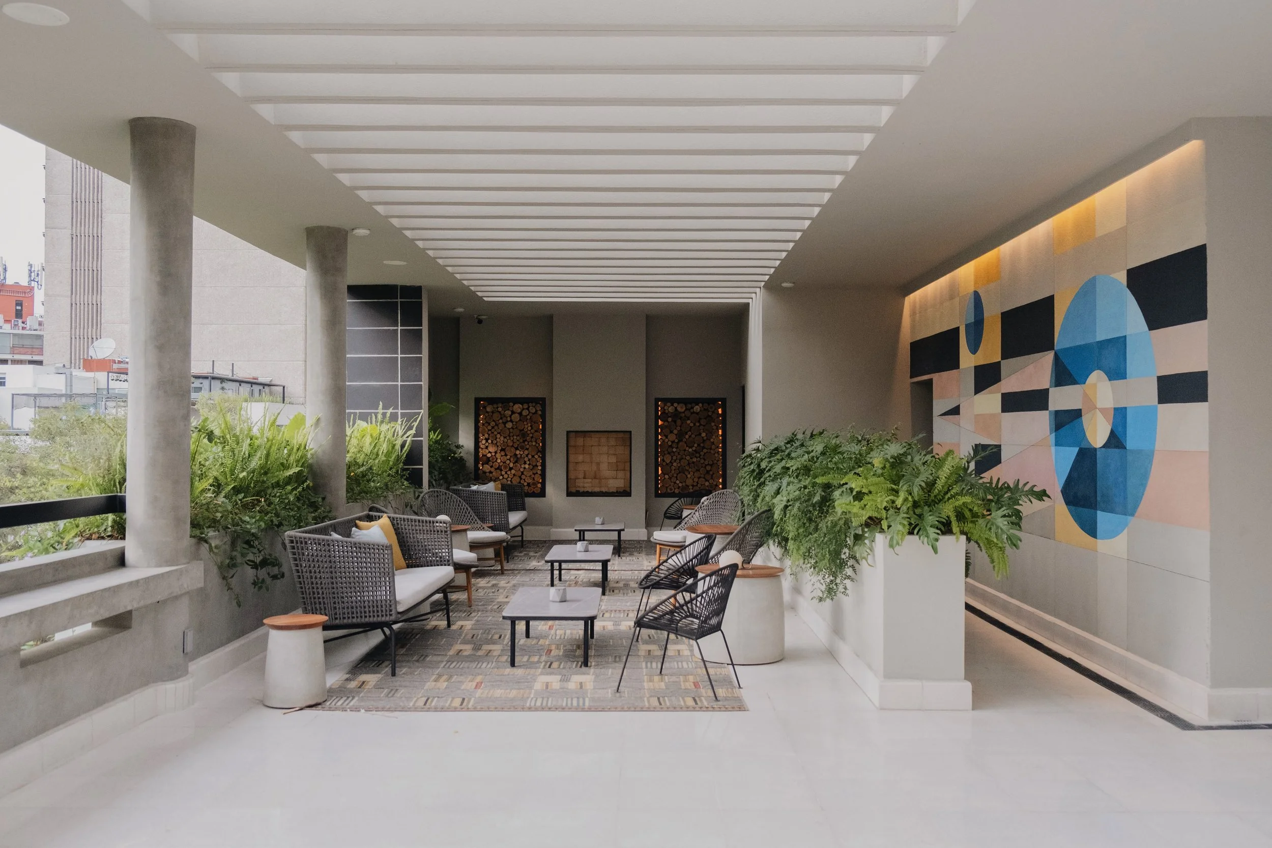 Outdoor seating area with plants surrounding it.