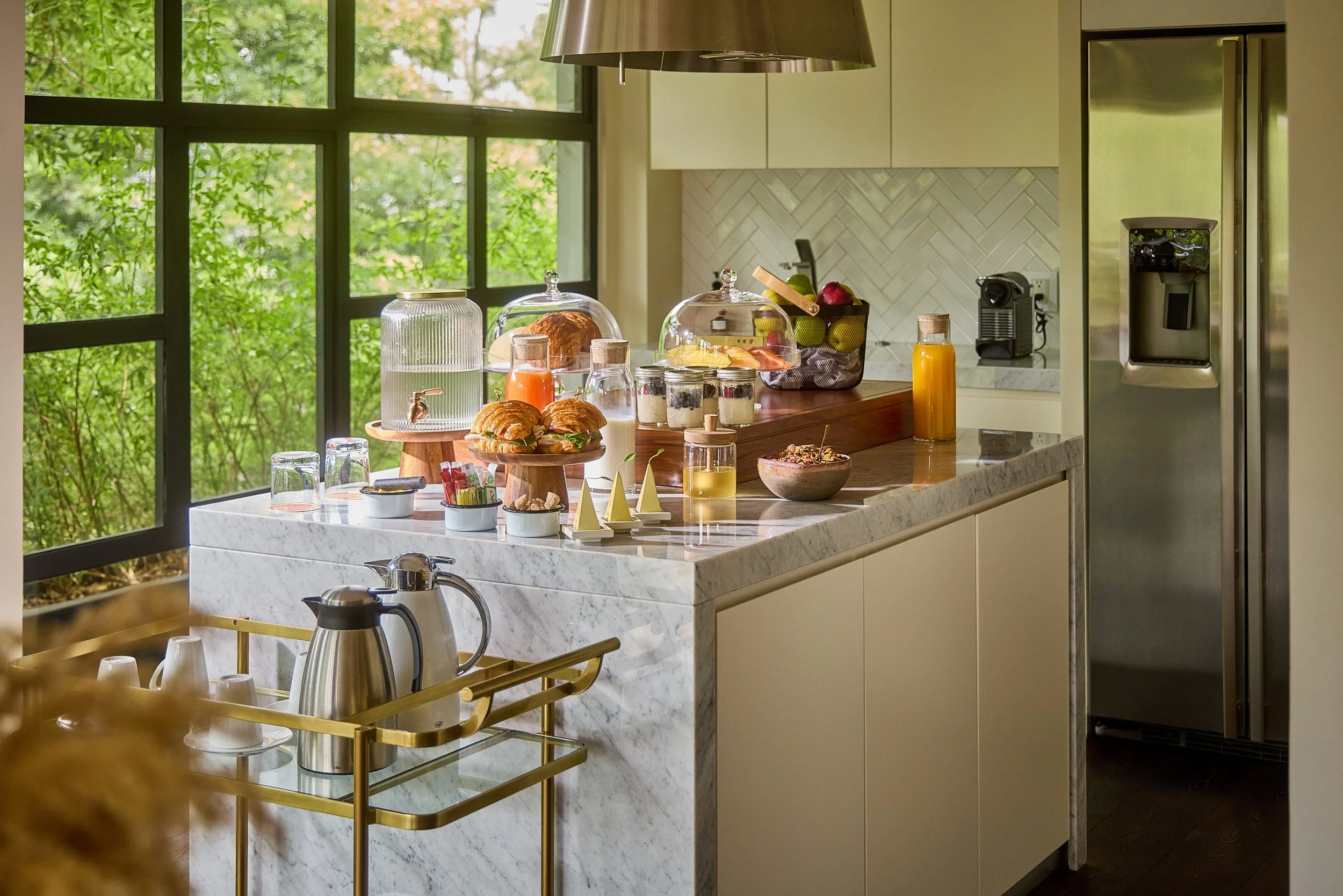 Breakfast spread atop a marble counter within the room's kitchen. 