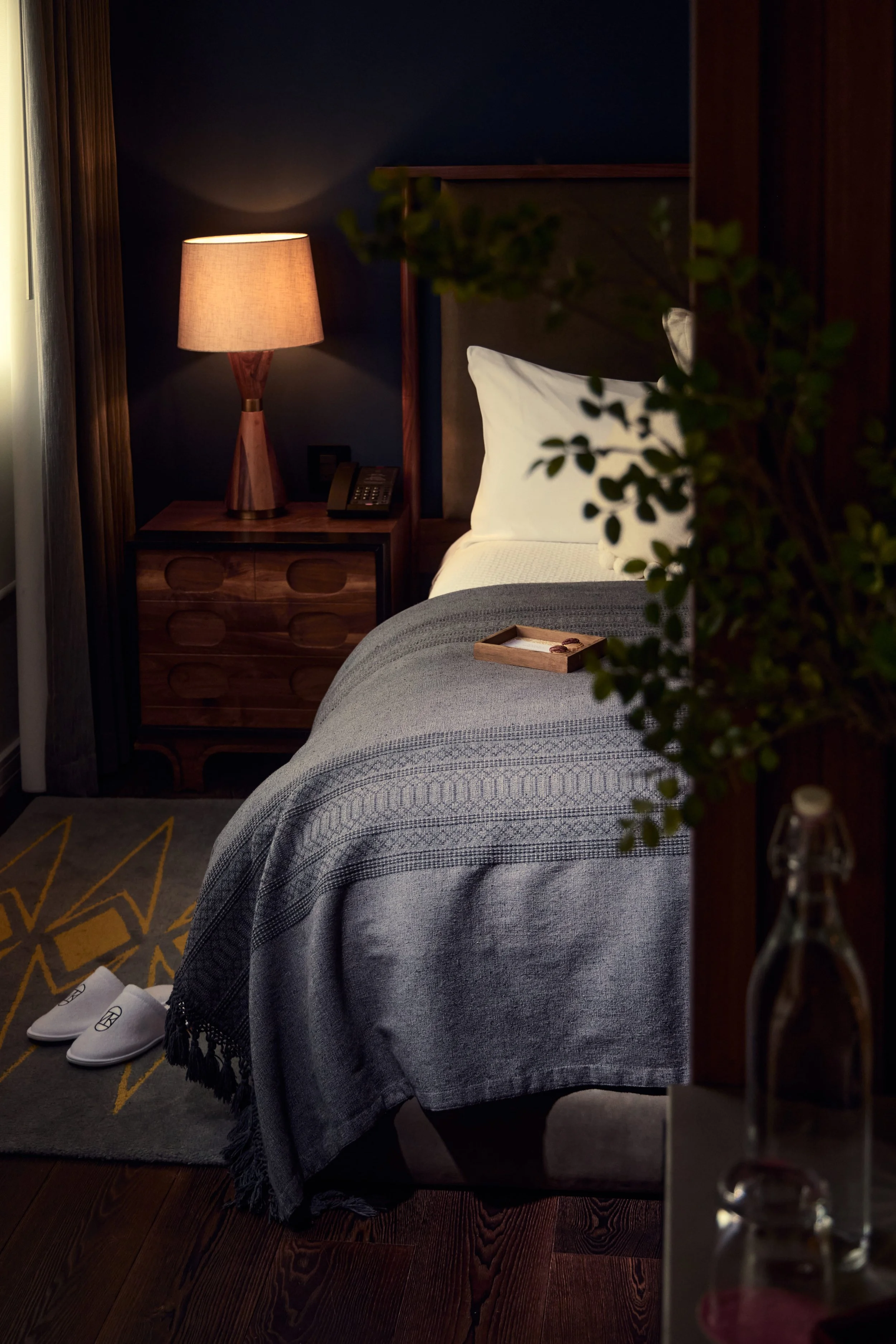 Hotel bedroom with wooden furnishings and lish decor