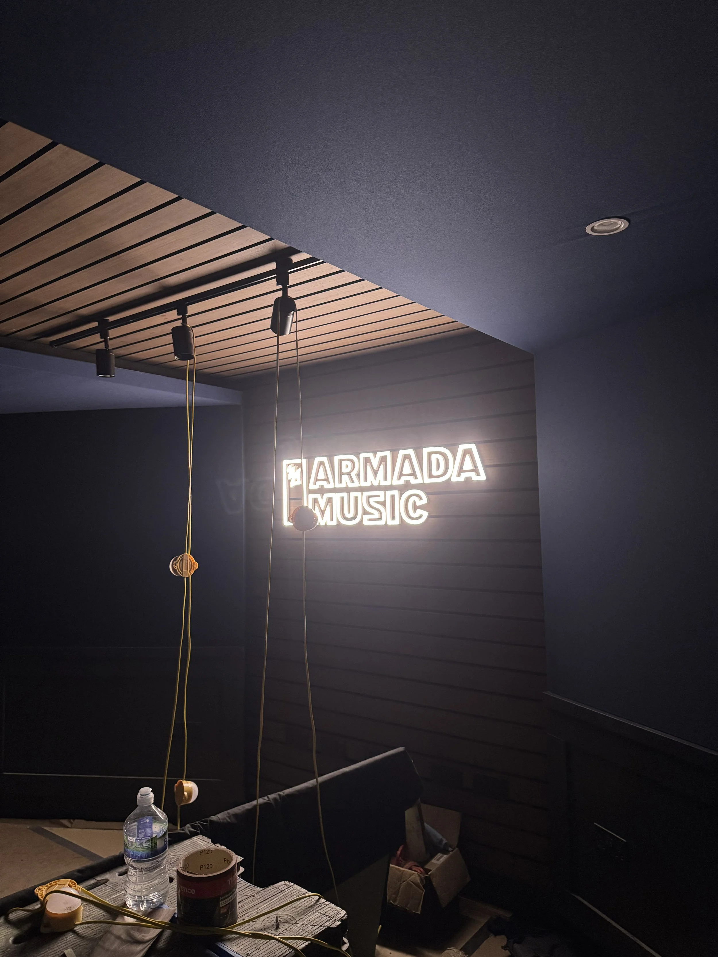 Studio 1 fit-out in progress at Armada Music, London, showing the front wall and Armada Music neon signage.