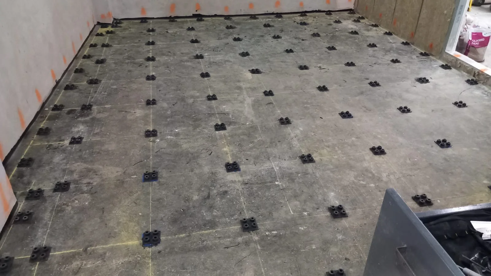 Floating floor installation in progress at Armada Music, London, showing setting out with anti-vibration pads.