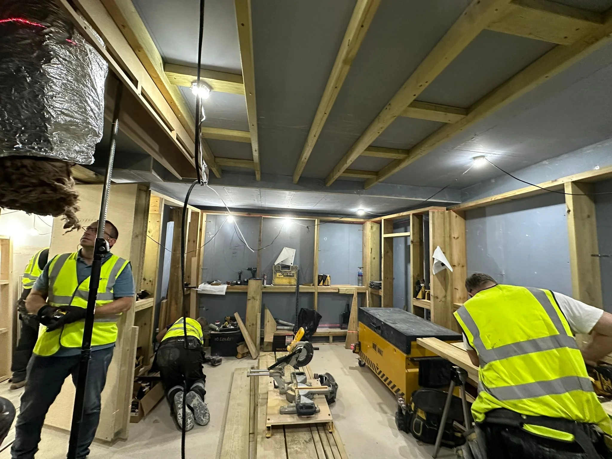 Studio 1 under construction at Armada Music, London, showing timber framing, first fix services and trades on site.