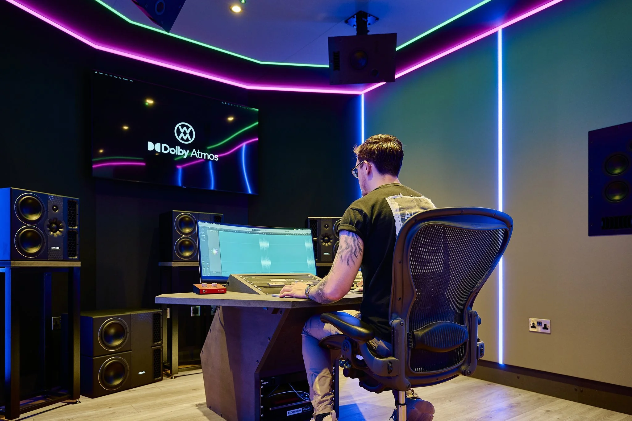 Dolby Atmos studio at Wired Masters, London, showing workstation, display and PMC 7.1.4 loudspeaker layout.