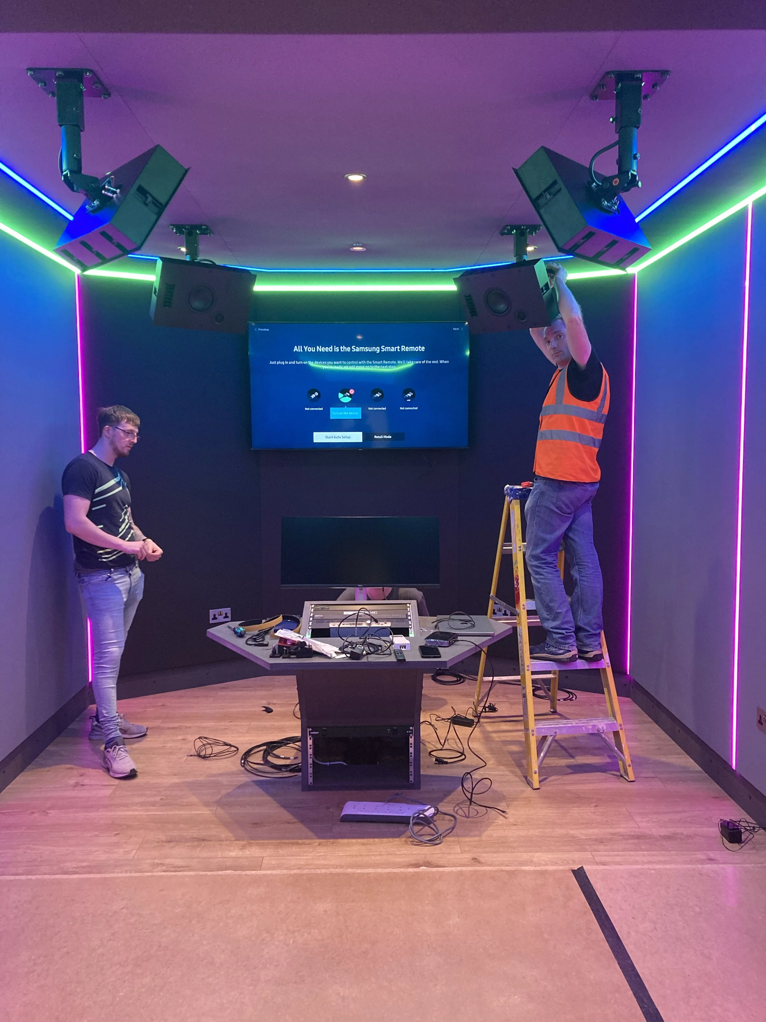 Works in progress in the Dolby Atmos studio at Wired Masters, London, showing engineer and client during height speaker installation.