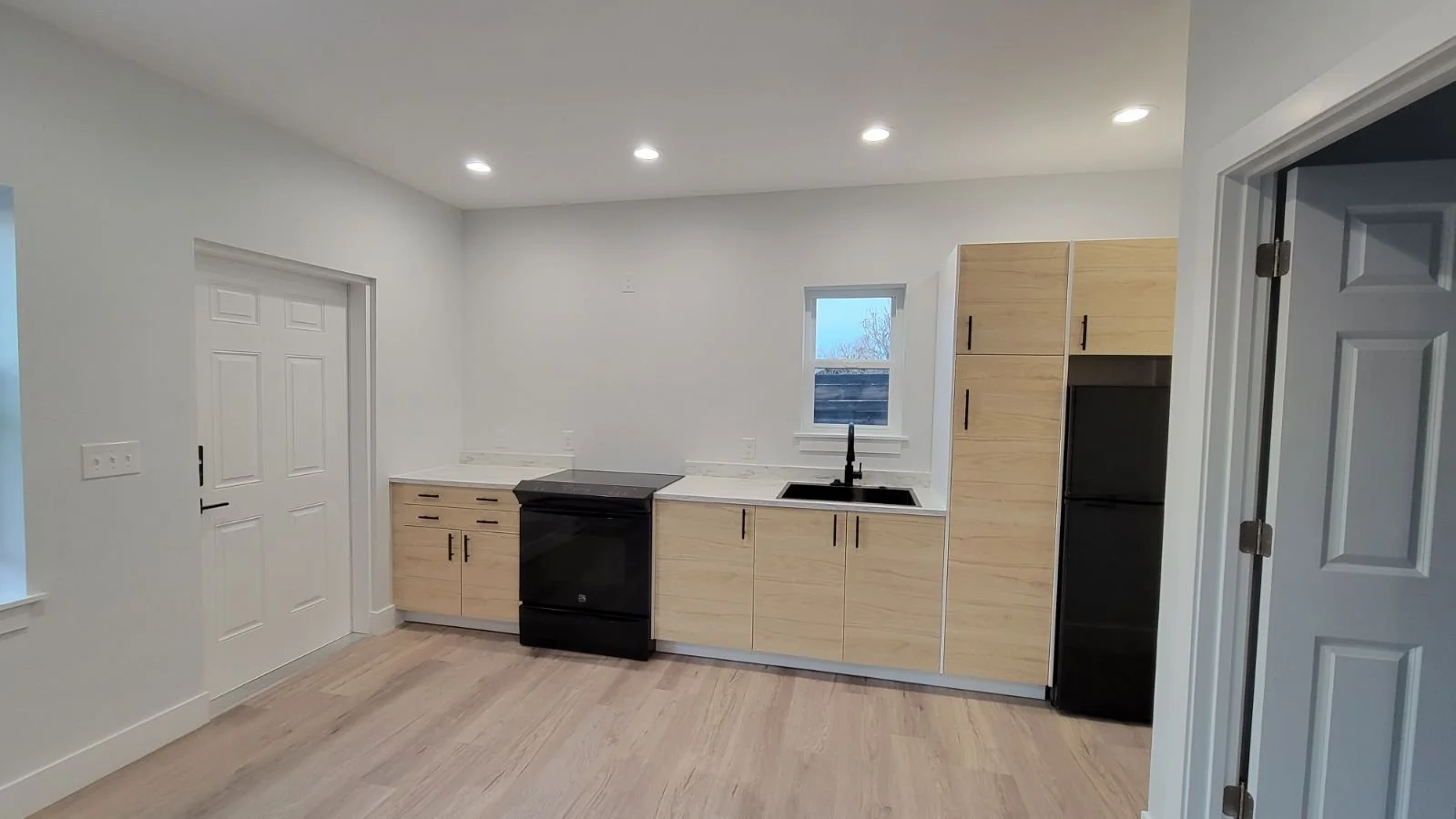 Finished kitchen inside a detached accessory dwelling unit in Denver, featuring compact cabinetry, modern appliances, and efficient layout by Prenvalley Builders.