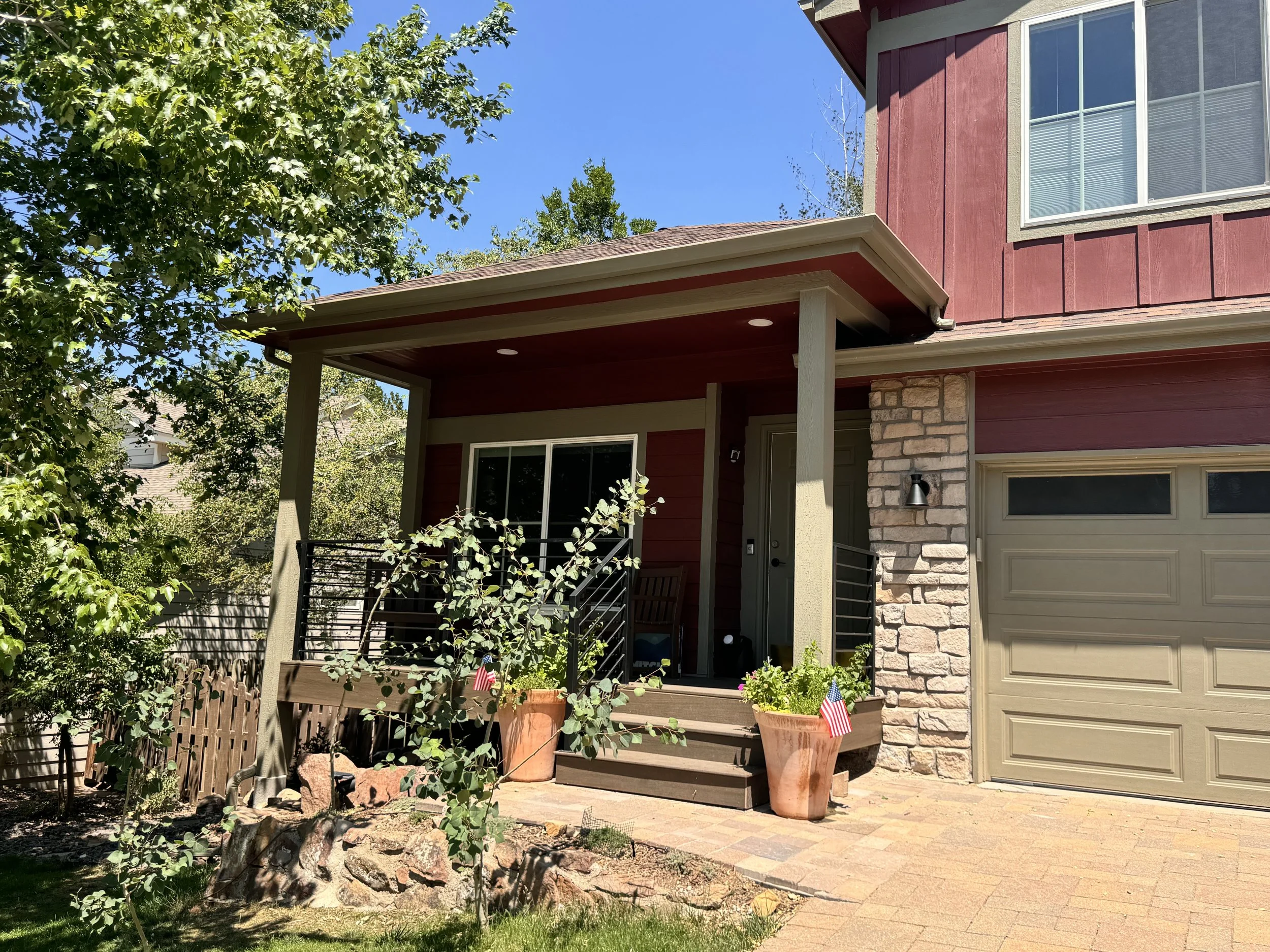 Completed covered front porch as part of a pop-top renovation in Golden, Colorado, integrated with the existing garage and second-story addition.