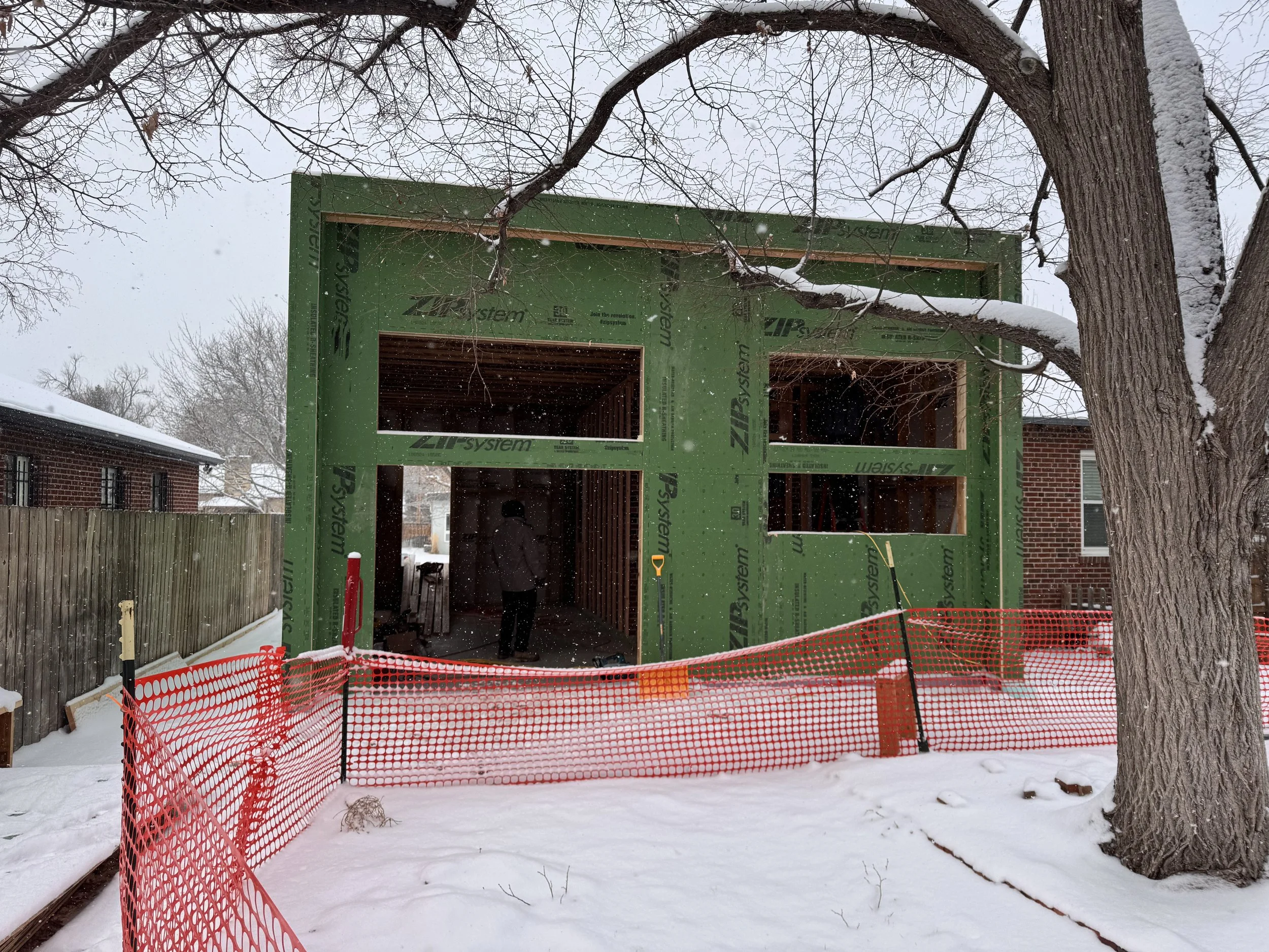 Front elevation of a Denver home addition showing framed window and door openings with ZIP System exterior sheathing installed by Prenvalley Builders.