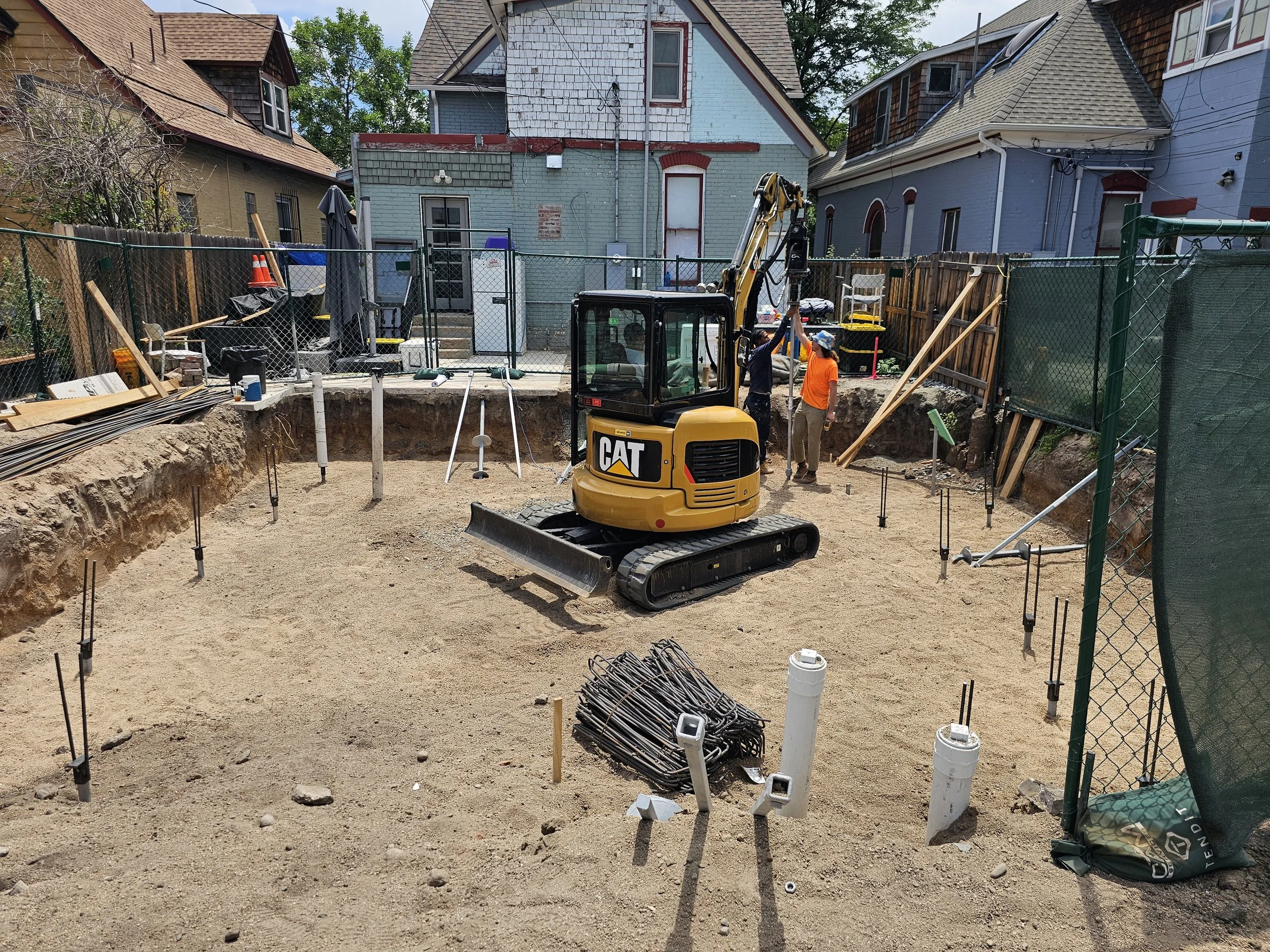 Accessory dwelling unit foundation preparation in Denver showing utility rough-ins, structural layout, and excavation work prior to concrete pour
